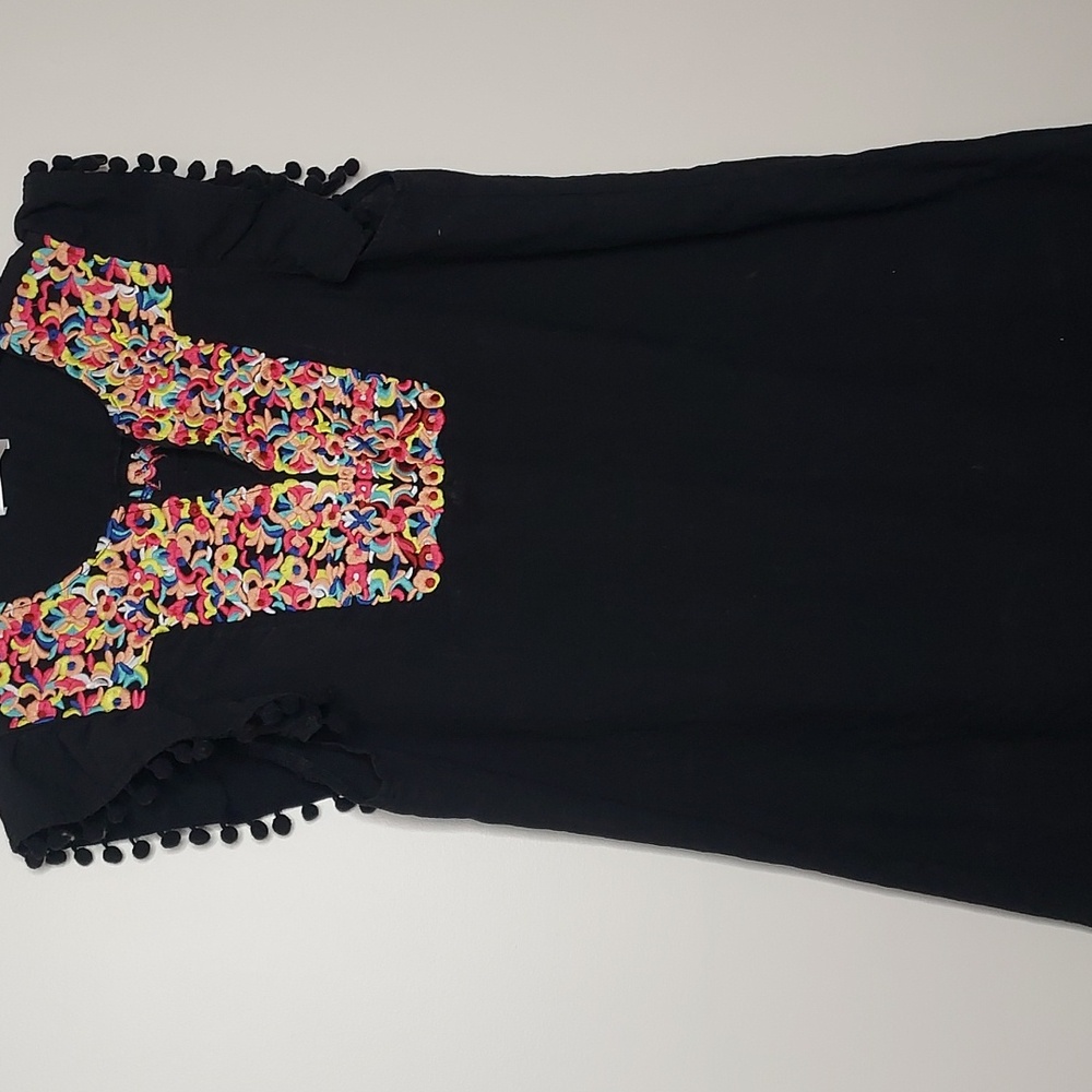 Large boho embroidery dress with pompoms on the short sleeves.